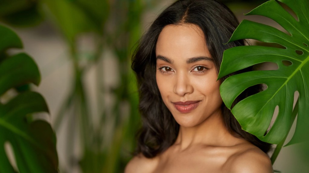 Client applying skincare after a facial routine