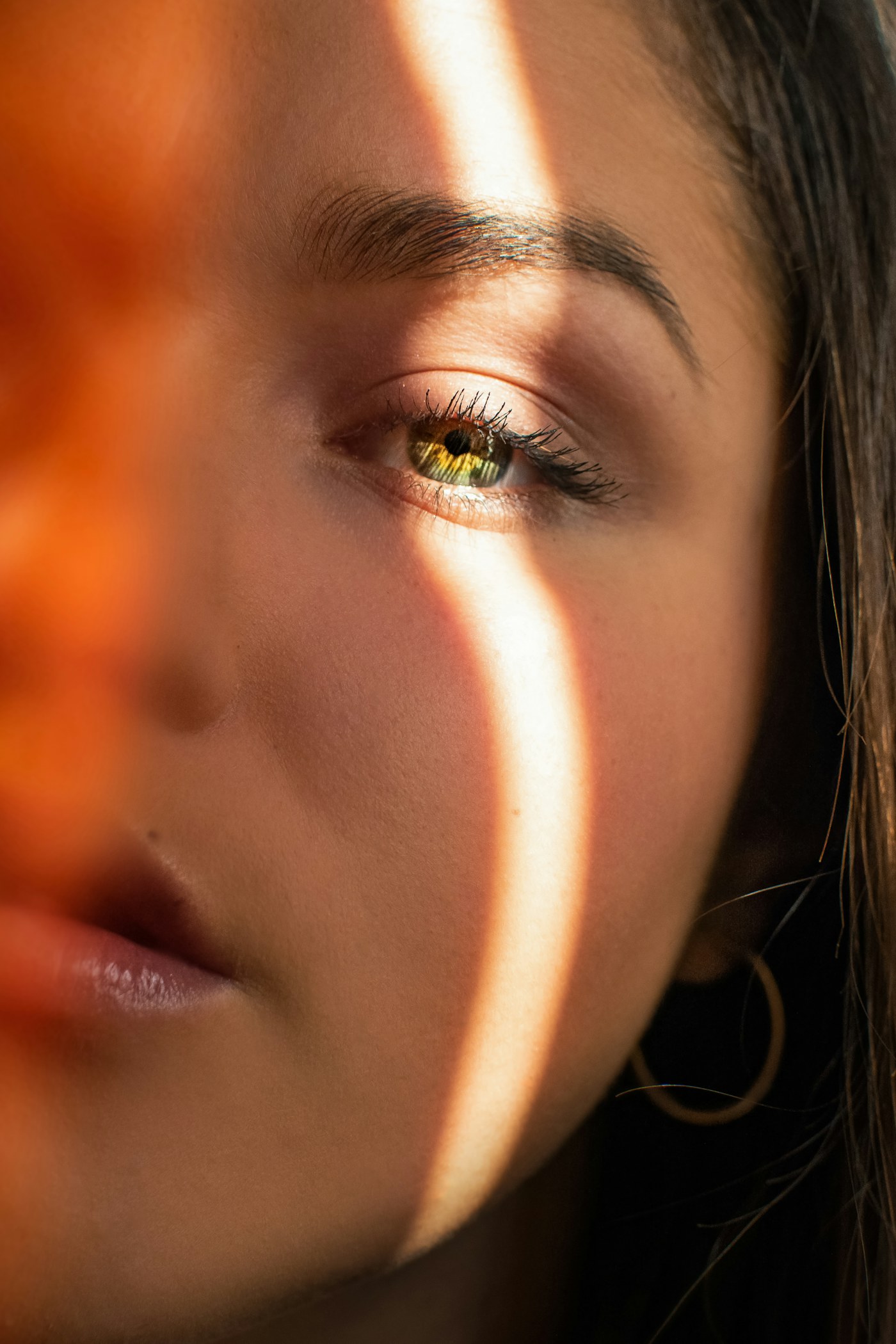 Close-up of skin and eye in warm light